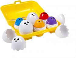 Yellow carton of colorful eggs and shells with faces to match.